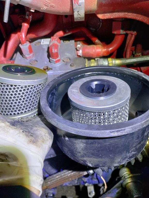 A new power steering filter going into the reservoir