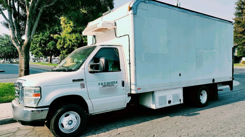 His white service truck with the P and D Mobile Service decal on the door