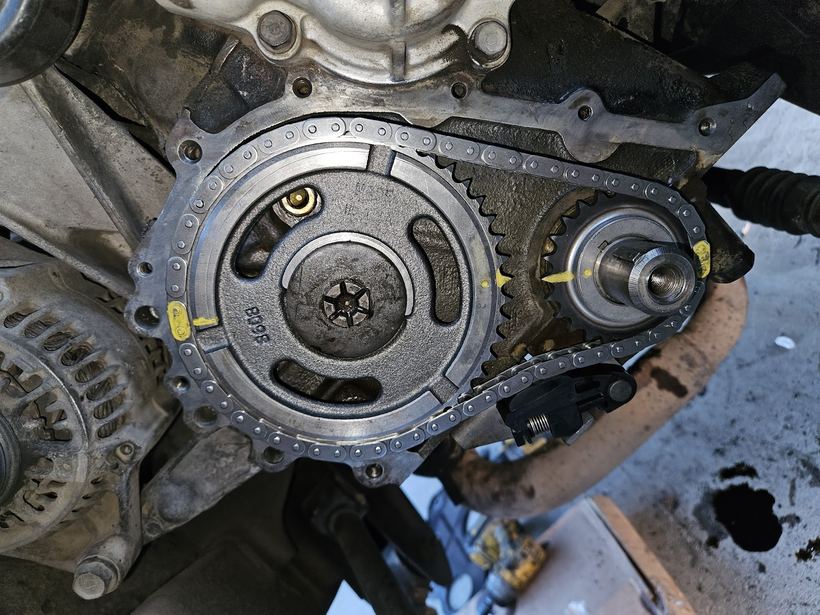 A timing chain and gears inside an opened engine